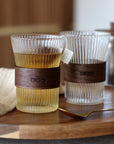 Twee glazen kopjes met thee op een houten dienblad